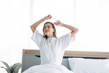 Sabah uyandıktan sonra esneme hareketleri yapan bir kadın. Güzel kadınlar ferahlatıcı bir şekilde uyanır..