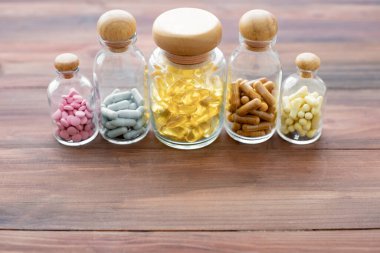 Top view of medicine in glass bottle on wood background with copy space. Concept of medicine in medical.