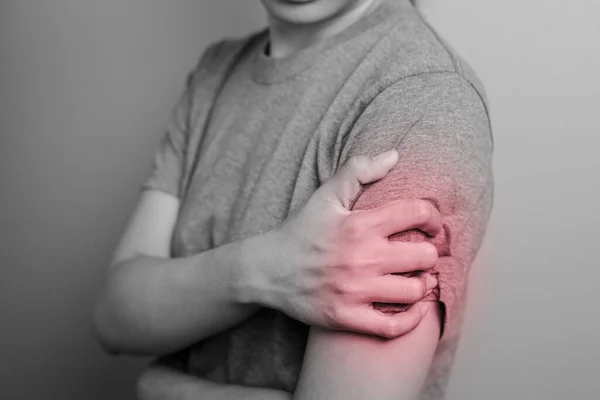 Woman suffering from pain in arm. Concept pain in arm. Young woman with pain in arm.