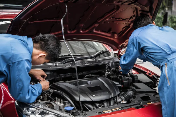 Two Auto Mechanic Doing Car Service Maintenance Repair Service Concept — стоковое фото