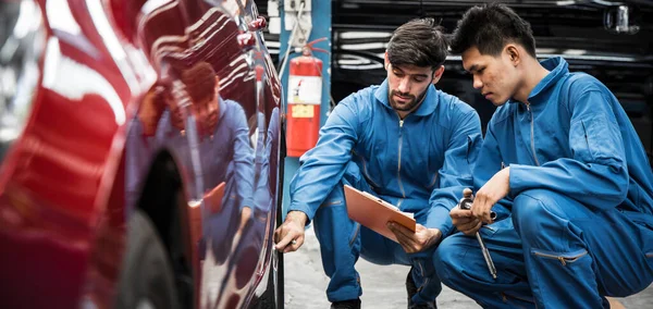 Two Auto Mechanic Doing Car Service Maintenance Wheel Mechanic Checking — Fotografia de Stock