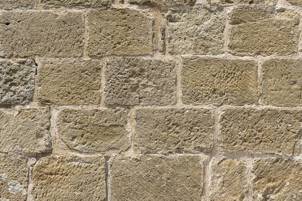 Detalhe da parede construída com blocos de pedra esculpida à mão — Fotografia de Stock