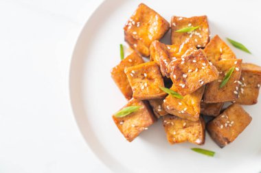 Beyaz susamlı kızarmış tofu ve teriyaki sosu. Vejetaryen ve vejetaryen yemek tarzı.