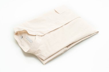 bej gömlek katlaması beyaz arkaplanda izole edildi