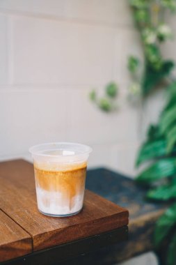 Ahşap masadaki kirli kahve bardağında.