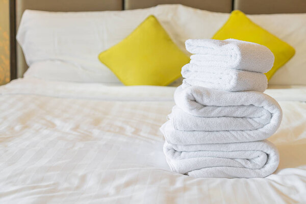 white towel fold on bed in hotel resort