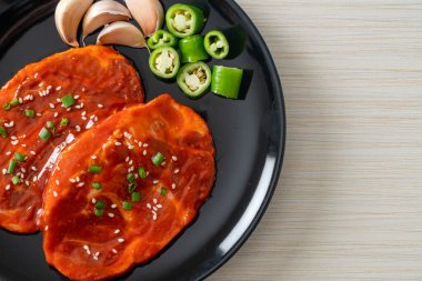 Kore usulü ızgara için baharatlı Kore ezmesiyle marine edilmiş domuz eti ya da taze domuz eti.