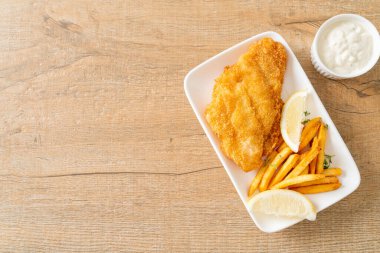 balık ve patates kızartması - kızarmış balık fileto patates cipsi ve limonlu beyaz tabak