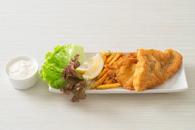 balık ve patates kızartması - kızarmış balık fileto patates cipsi ve limonlu beyaz tabak