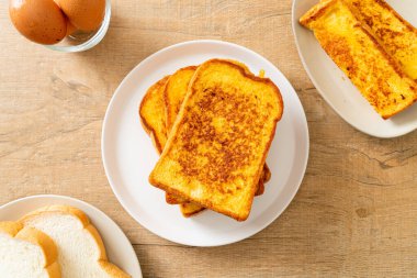 Kahvaltı için beyaz tabakta yumurtalı ekmek.