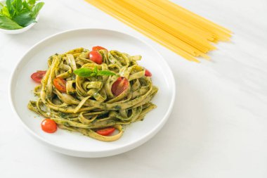pesto soslu ve domatesli makarna vejetaryen ve vejetaryen yemek tarzı.