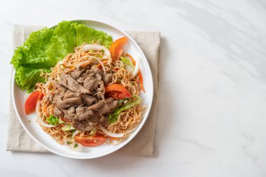 Beyaz tabakta domuz etli hazır şehriye salatası. Asya usulü.