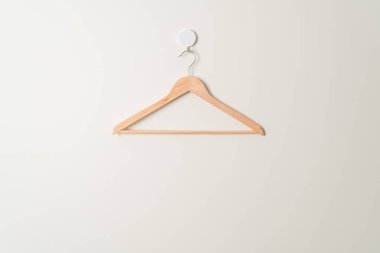 empty wood clothes hanger on wall