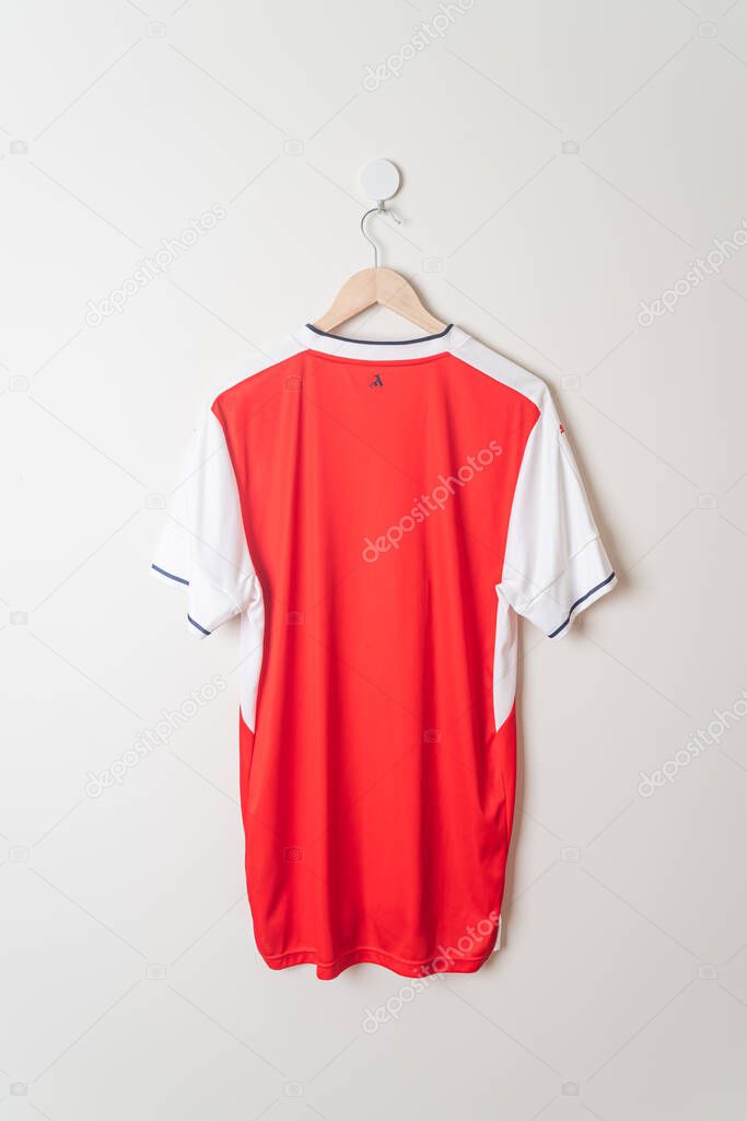 Bangkok, Thailand - Jan 18, 2022 : Arsenal retro shirt home jersey season 2016-2017 hanging on wall