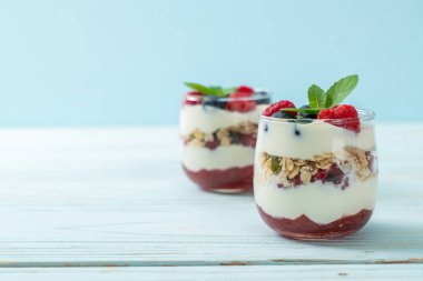 Ev yapımı ahududu ve yaban mersinli yoğurt ve granola. Sağlıklı yemek tarzı.