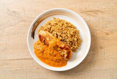 Kırmızı köri soslu ızgara tavuk bifteği ve pilav. Müslüman usulü.