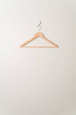 empty wood clothes hanger on wall