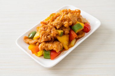 Kızarmış tatlı ve ekşi sosla domuz ve sebzeyi karıştır.