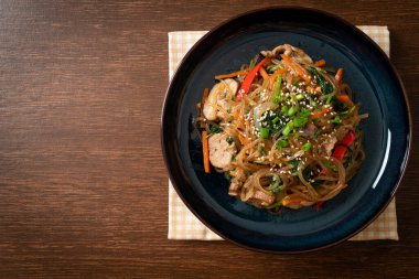 Japchae ya da karışık Kore vermicelli erişte sebzeli ve üzerine beyaz susamlı domuz eti - Kore geleneksel yemek tarzı