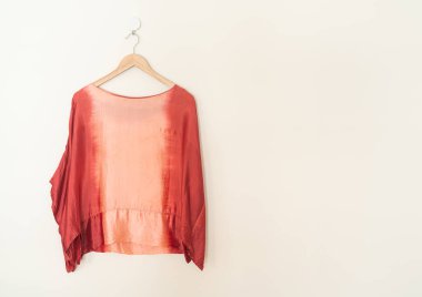 tie dye shirt hanging with wood hanger on wall