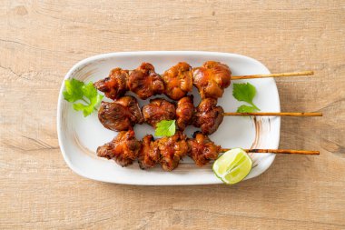 Izgara tavuk şişi. Tabakta baharat ve şifalı otlar var.