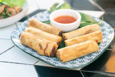 Tabağında sos olan kızarmış Çin böreği.