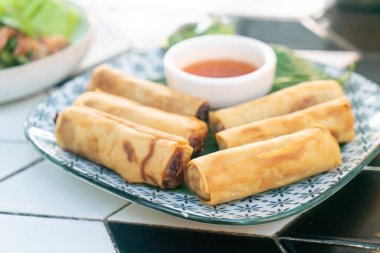 Tabağında sos olan kızarmış Çin böreği.