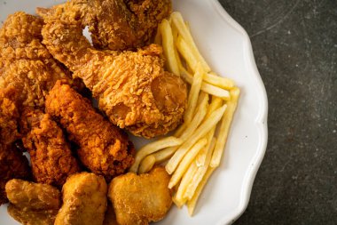 Patates kızartmalı kızarmış tavuk ve tabakta nugget - sağlıksız yemek.