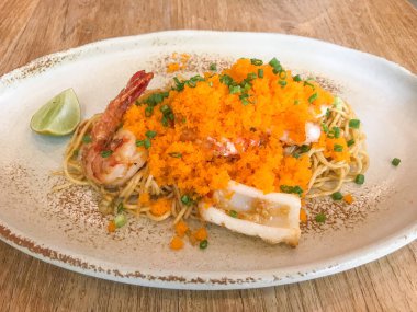 Karışık kızarmış saç spagettisi, deniz ürünleri ve karides yumurtası.