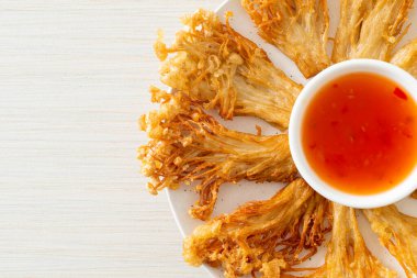 Kızarmış enoki mantarı ya da baharatlı soslu altın iğneli mantar - vejetaryen yemek tarzı.