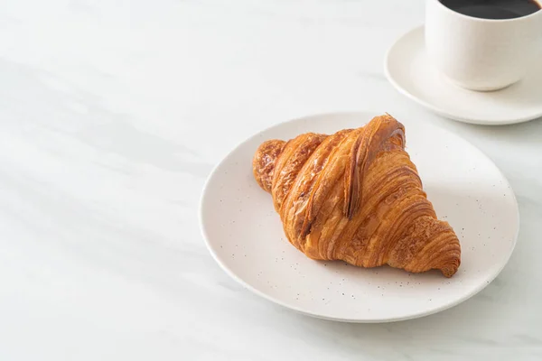 Frisches Croissant Auf Weißem Teller Mit Schwarzem Kaffee — Stockfoto