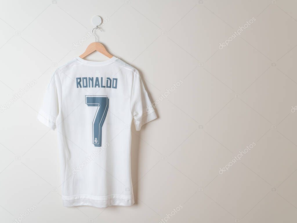 Bangkok, Thailand - Jan 18, 2022 :  Real Madrid shirt home jersey season 2014-2015 with Ronaldo name hanging on wall