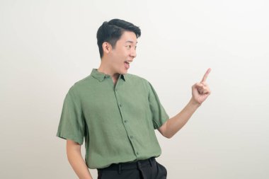 Beyaz arkaplanı işaret eden Asyalı bir adam.