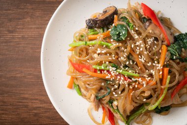 Japchae ya da karışık Kore vermicelli erişte sebzeli ve üzerine beyaz susamlı domuz eti - Kore geleneksel yemek tarzı