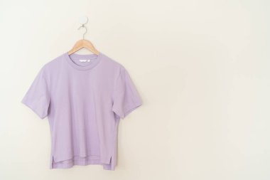 woman t-shirt hanging with wood hanger on wall