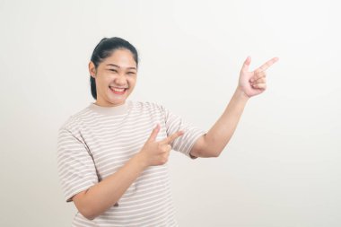 Asian woman with hand pointing on wall