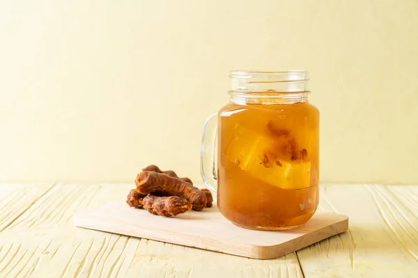 Delicious sweet drink tamarind juice and ice cube - healthy drink style