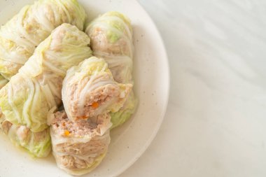 Çin lahanasına sarılı ev yapımı kıymalı domuz eti ya da haşlanmış lahana.