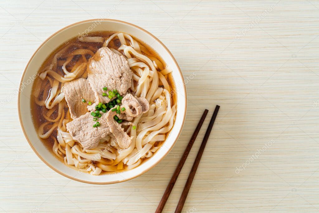 homemade udon ramen noodles with pork in soy or shoyu soup