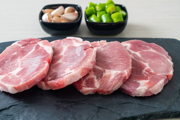 Taze domuz boyunlu ya da yakalı domuz eti ve terbiye edilecek malzemeler.