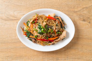 Japchae ya da karışık Kore vermicelli erişte sebzeli ve üzerine beyaz susamlı domuz eti - Kore geleneksel yemek tarzı