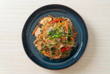 Japchae ya da karışık Kore vermicelli erişte sebzeli ve üzerine beyaz susamlı domuz eti - Kore geleneksel yemek tarzı