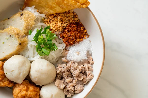 spicy small flat rice noodles with fish balls and shrimp balls without soup - Asian food style