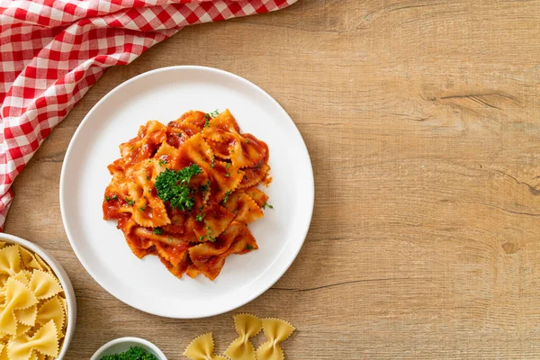 farfalle pasta in tomato sauce with parsley - Italian food style