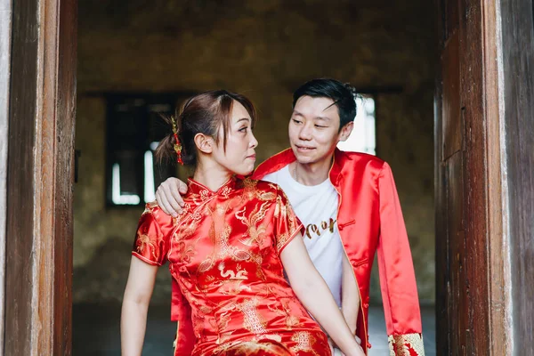 Happy young Asian couple love in Chinese traditional dresses - Red is the main color of the traditional festive that including wedding in China.