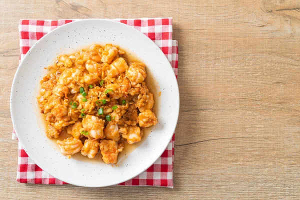 stir-fried shrimps with garlic and shrimps paste on whie plate