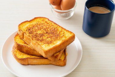 Kahvaltı için beyaz tabakta yumurtalı ekmek.