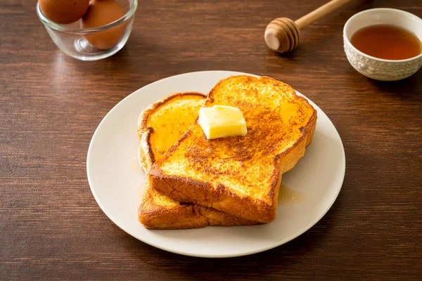 French toasted with butter and honey for breakfast