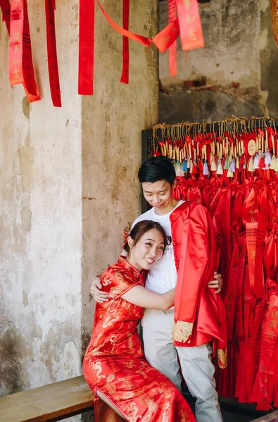 Happy young Asian couple love in Chinese traditional dresses - Red is the main color of the traditional festive that including wedding in China.