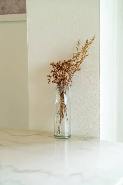 dried flowers in glass vase decoration on table